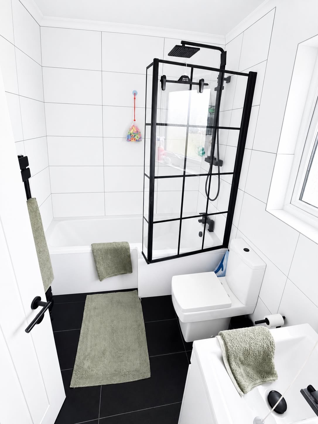 Black and white bathroom with Crittall-style shower screen